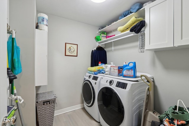 washroom with light wood finished floors, independent washer and dryer, and baseboards