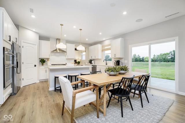 dining room with light wood-style flooring, visible vents, and recessed lighting