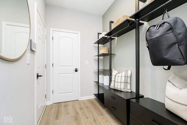 mudroom featuring light wood-style flooring and baseboards