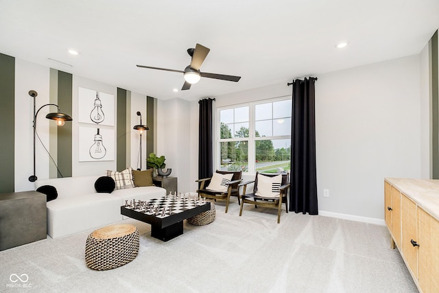 sitting room featuring light carpet, baseboards, a ceiling fan, and recessed lighting