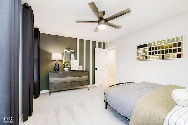 carpeted bedroom with baseboards, visible vents, and a ceiling fan