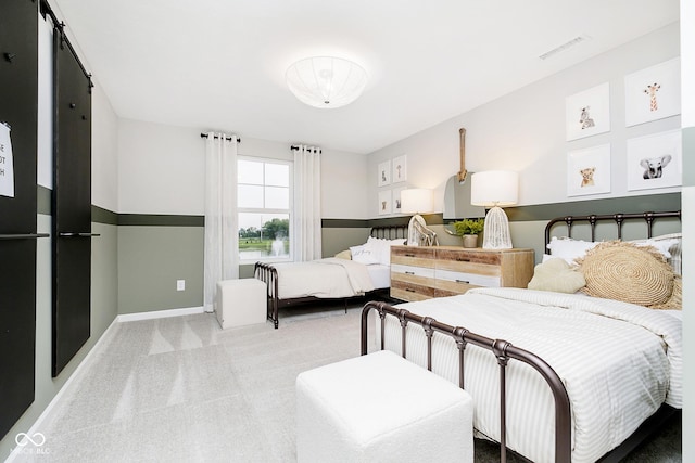 carpeted bedroom with visible vents and baseboards