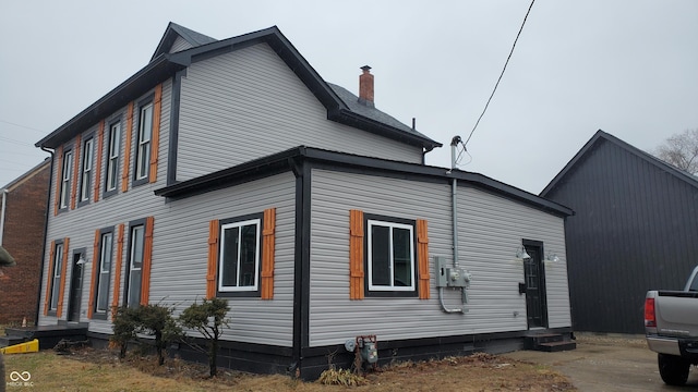 view of side of property featuring entry steps