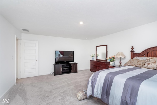 bedroom featuring carpet floors, visible vents, and baseboards