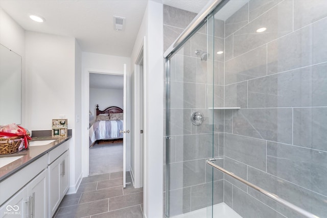 bathroom with tile patterned flooring, double vanity, visible vents, connected bathroom, and a stall shower