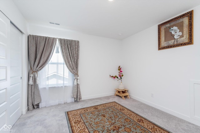 empty room featuring baseboards, visible vents, and carpet