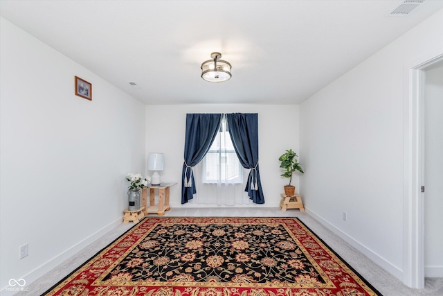 living area with baseboards and visible vents