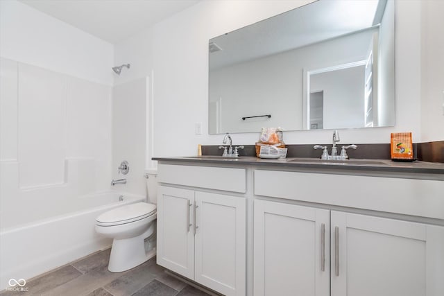 full bath with toilet, a sink, double vanity, and shower / bathing tub combination