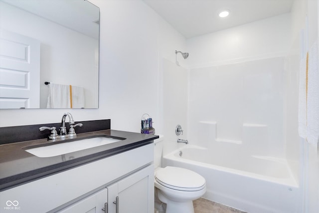 full bath with shower / bath combination, vanity, tile patterned floors, and toilet
