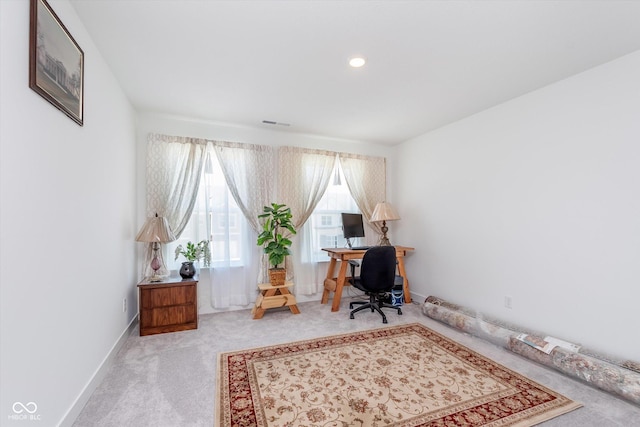 carpeted office with baseboards and visible vents