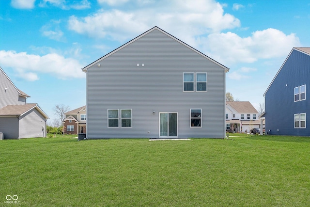rear view of house featuring a yard