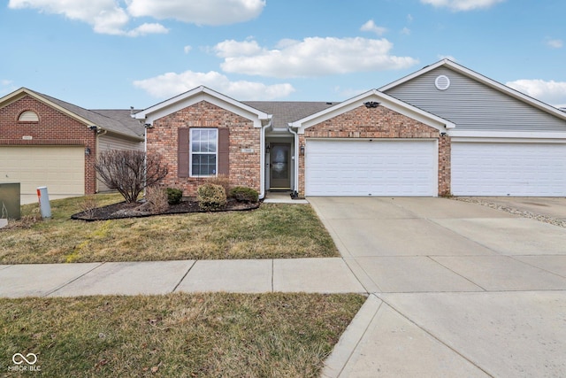 single story home with a garage, a front yard, brick siding, and driveway