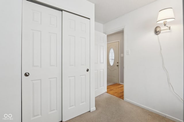 unfurnished bedroom with a closet, carpet flooring, and baseboards