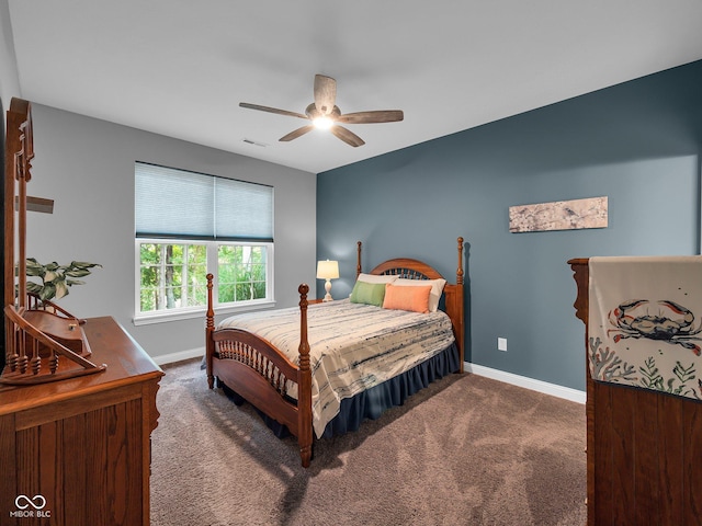 carpeted bedroom with a ceiling fan, visible vents, and baseboards