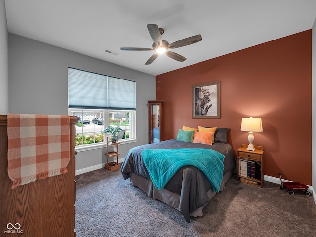 carpeted bedroom with a ceiling fan, visible vents, and baseboards