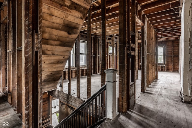 misc room with vaulted ceiling and an upstairs landing