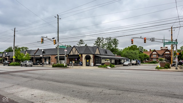 exterior space with sidewalks, traffic lights, traffic signs, and curbs