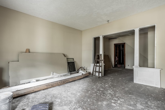 unfurnished room with a textured ceiling