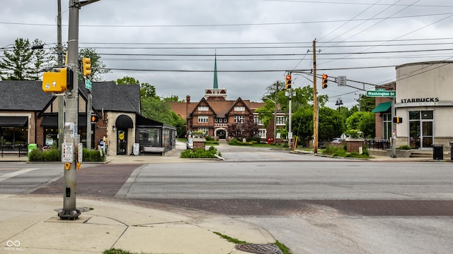 view of street with traffic lights, curbs, and sidewalks