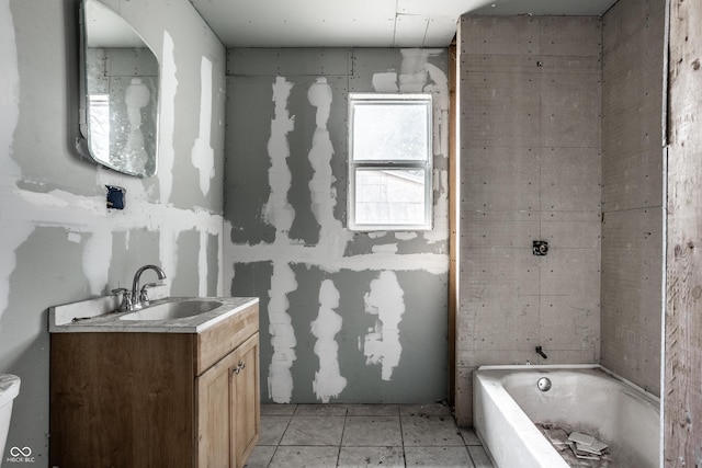 bathroom with tile patterned floors, vanity, and a tub