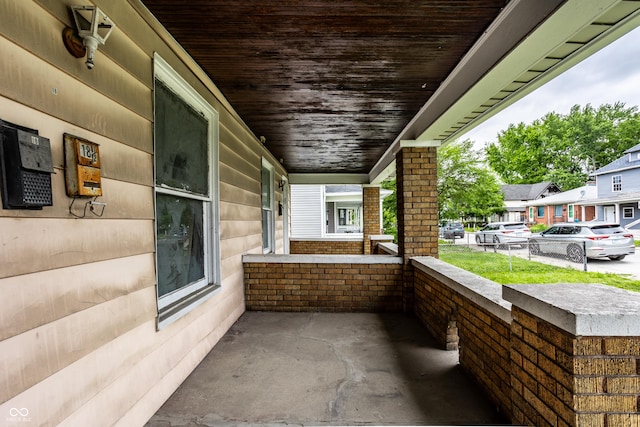 view of patio / terrace with a residential view and a porch