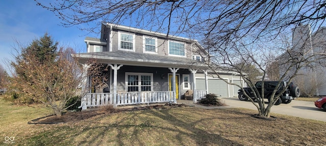 view of front of property with an attached garage, driveway, a porch, and a front yard