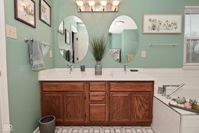 bathroom with a relaxing tiled tub, a sink, and double vanity