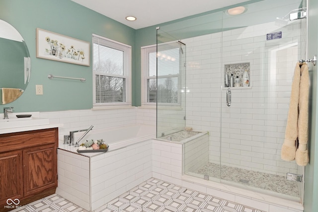 full bathroom featuring a bath, a stall shower, vanity, and tile patterned floors