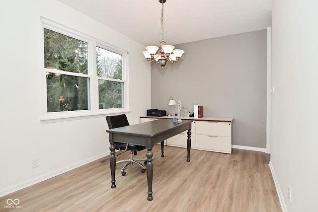 home office with light wood-type flooring, a notable chandelier, and baseboards