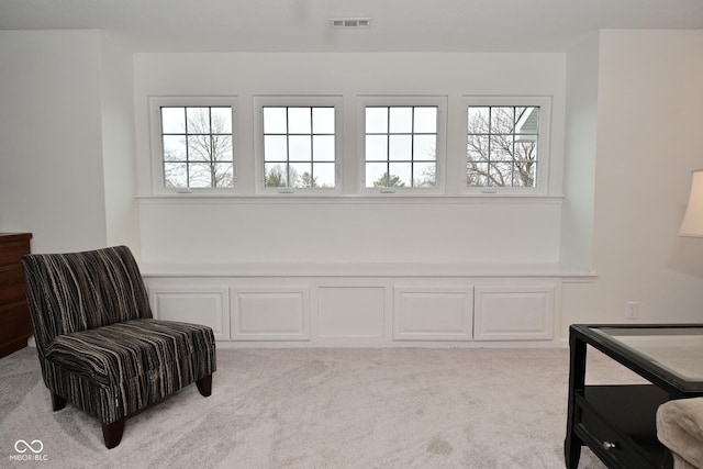 sitting room with carpet floors and visible vents