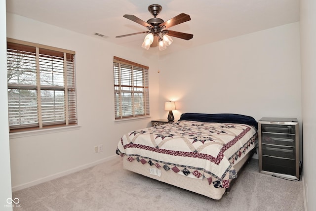 bedroom with carpet, visible vents, ceiling fan, and baseboards