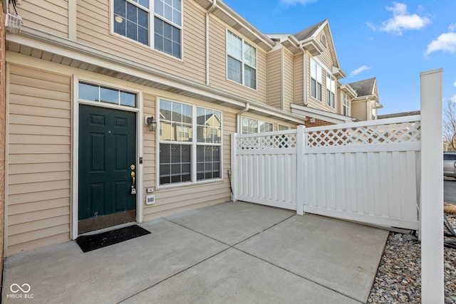 property entrance featuring a patio area and fence