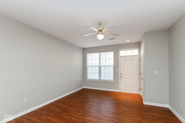 interior space with ceiling fan, dark wood-style flooring, visible vents, and baseboards