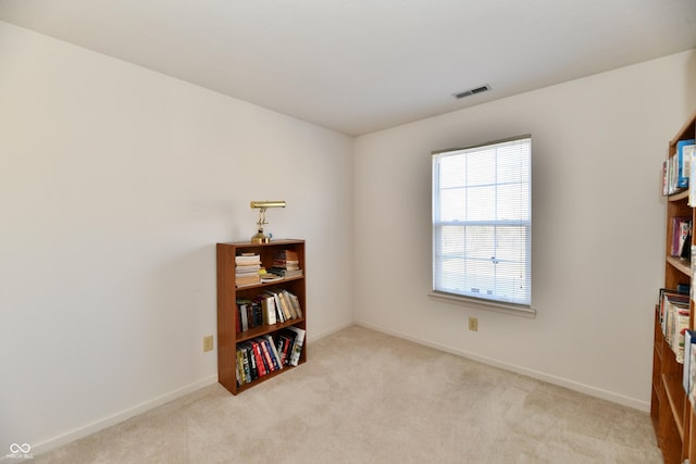 misc room featuring visible vents, baseboards, and light colored carpet