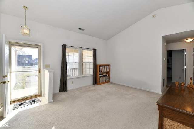 carpeted foyer entrance featuring vaulted ceiling, plenty of natural light, baseboards, and visible vents