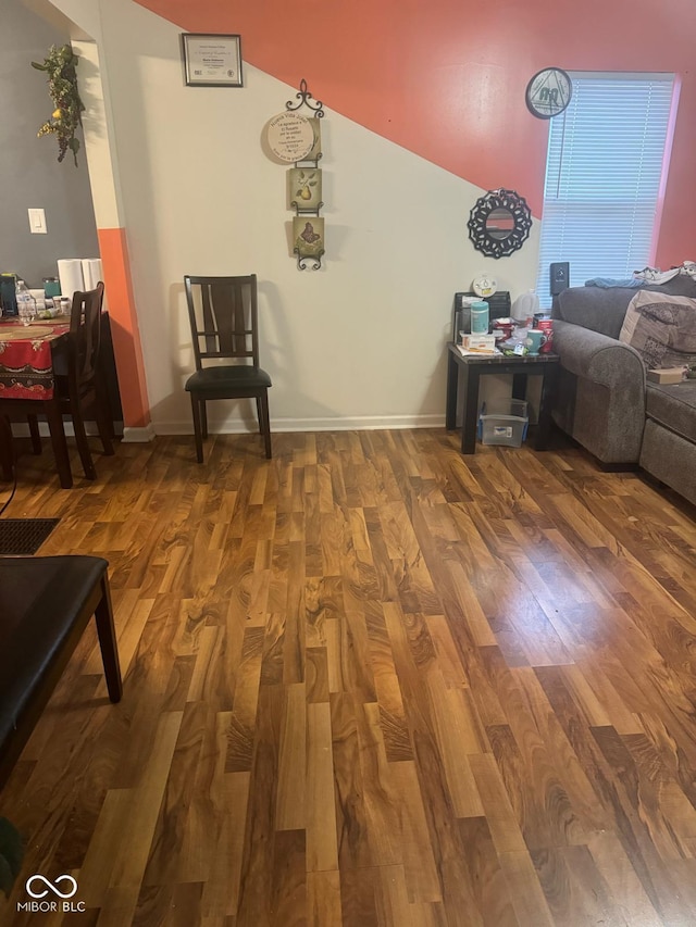 interior space featuring baseboards and wood finished floors