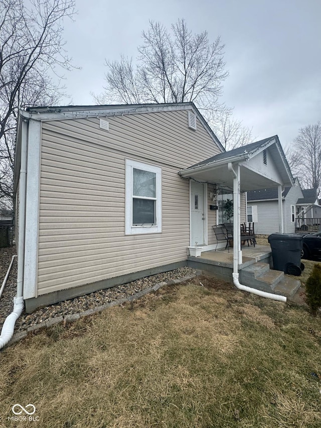 rear view of house featuring a yard