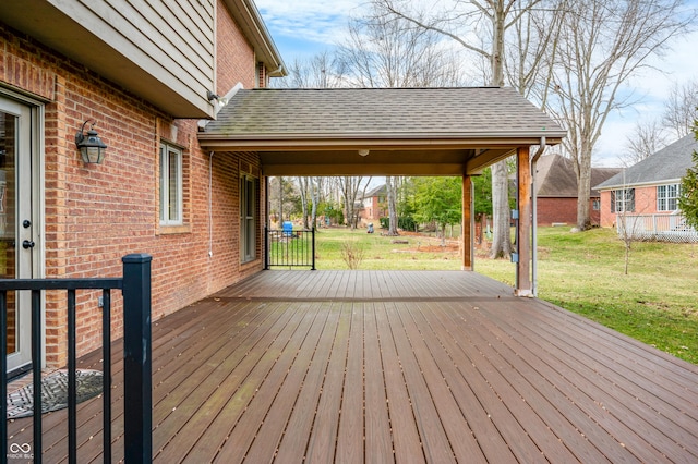 wooden deck featuring a yard