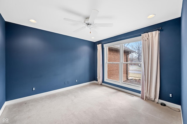 unfurnished room with carpet floors, recessed lighting, visible vents, ceiling fan, and baseboards