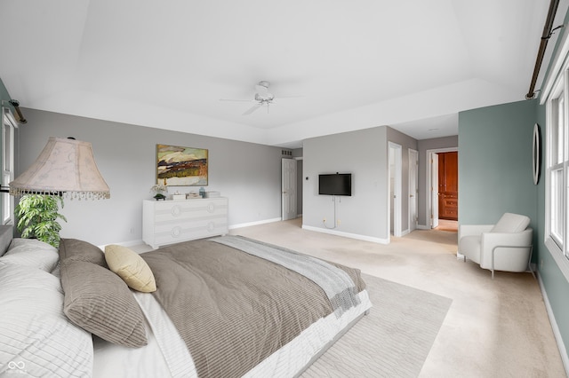 bedroom featuring light carpet, ceiling fan, baseboards, and vaulted ceiling