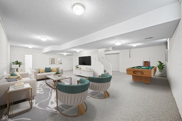 living area with carpet floors, billiards, and a textured ceiling