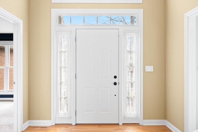 entrance foyer with light wood-style floors, baseboards, and visible vents