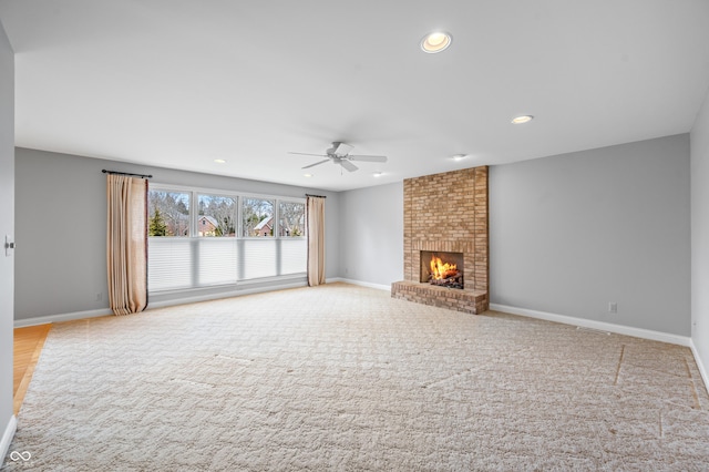 unfurnished living room with recessed lighting, a fireplace, baseboards, and ceiling fan