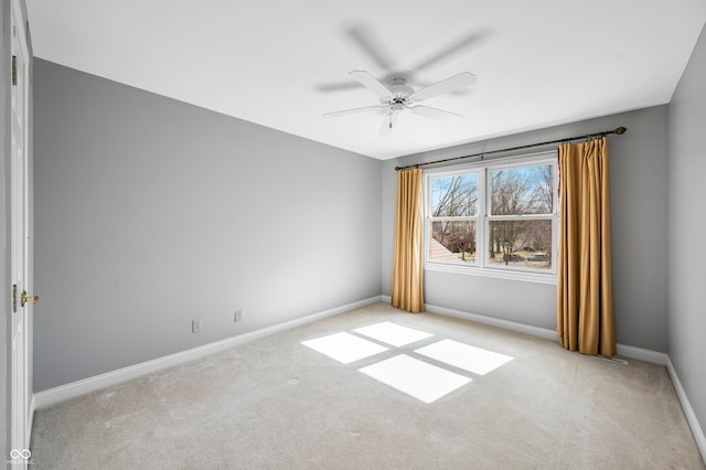 unfurnished room featuring light carpet, ceiling fan, and baseboards