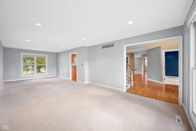 unfurnished room featuring light carpet, recessed lighting, visible vents, and baseboards