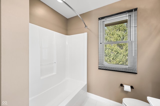 bathroom featuring shower / tub combination, tile patterned floors, toilet, and baseboards