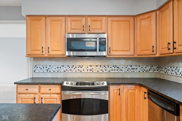 kitchen with dark countertops, tasteful backsplash, and stainless steel appliances