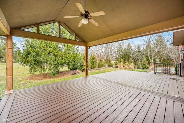 wooden terrace with ceiling fan and a yard