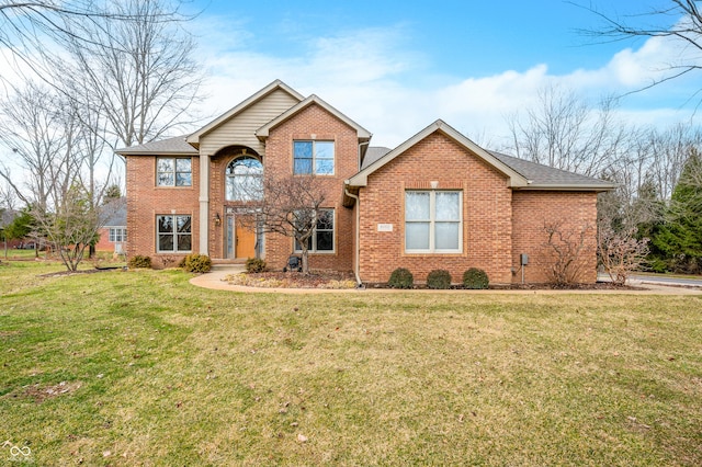 traditional-style home featuring brick siding, roof with shingles, and a front yard