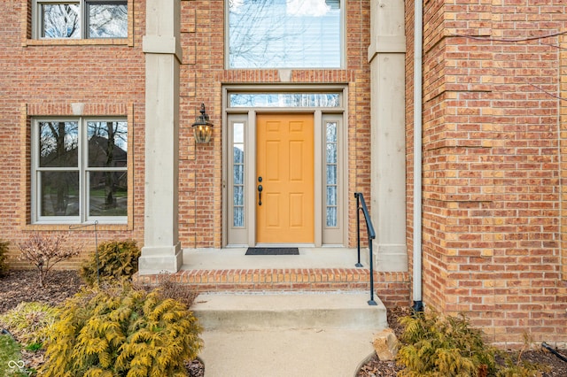 view of exterior entry with brick siding